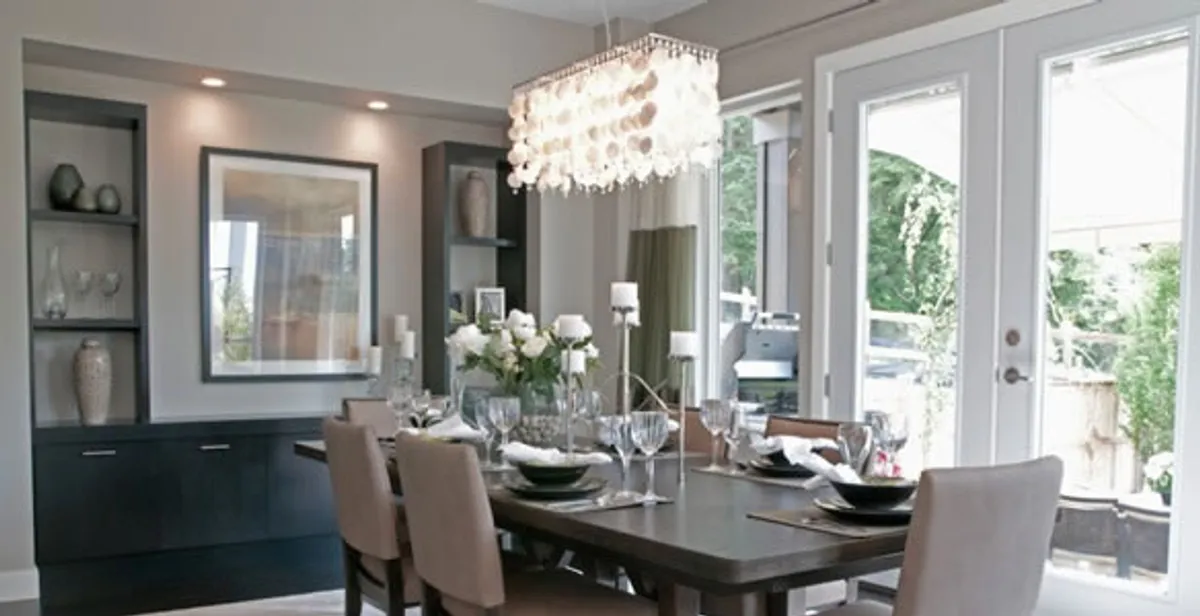 Elegant dining room chandelier installation above table in Dayton, OH