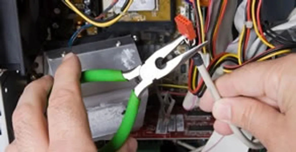 Licensed electrical contractor performing electrical repair with tools in Medway, OH