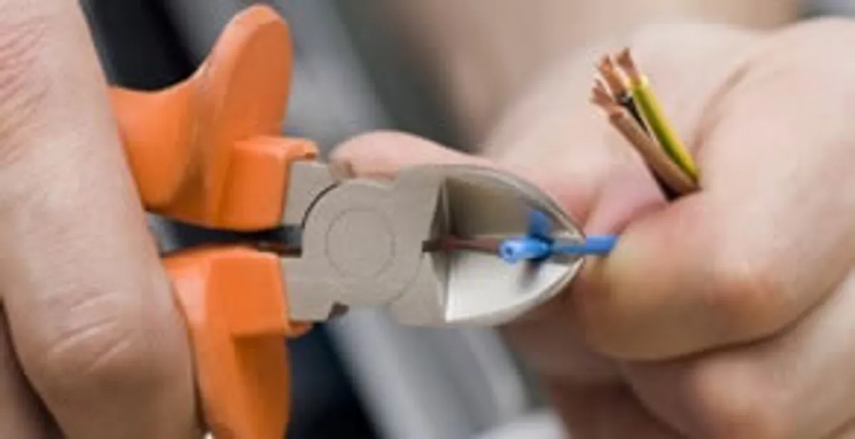 professional electrical services showing precise wire cutting by licensed electricians in Dayton, OH